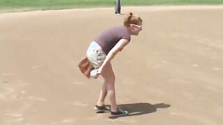 Coach shows 2 female athletes how to properly handle a big bat